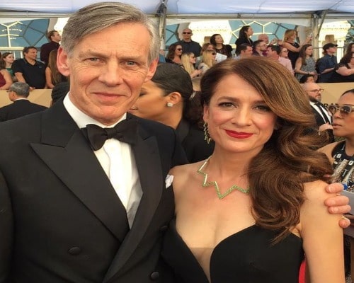 Picture of Douglas with his co-actress Raquel Cassidy posing for a photoshoot at an event wearing black dresses